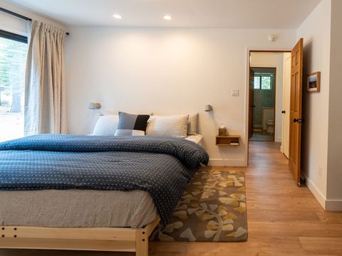 The spacious primary bedroom features a king latex bed with a chemical-free wool comforter and flannel duvet. All linens and bath towels are organic and/or OEKO-TEX certified. 