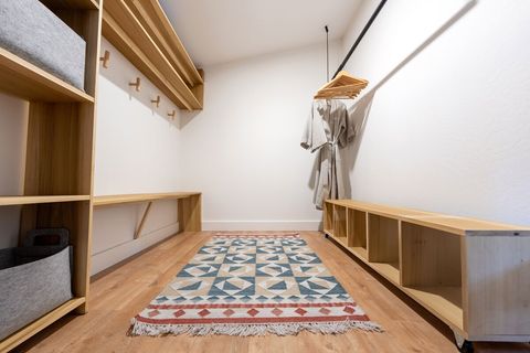 The custom closet features plenty of hooks, shelves and cubbies for clothes and other storage. 