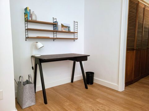 Primary bedroom workspace features a Blu Dot desk and string shelving.