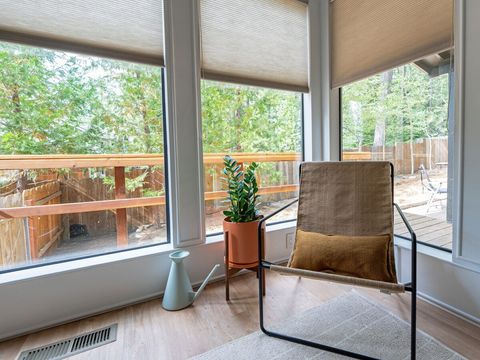 Relax in the Ferm Living corner chair overlooking the backyard.