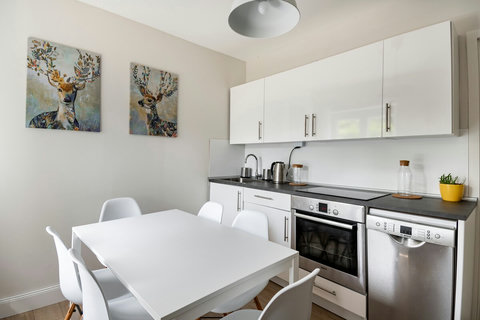 Fully equipped kitchen with everything you need for cooking, including plates, glasses, cups, mugs, pans, and pots. You will find an oven, dishwasher, coffee maker (Dolce Gusto capsule compatible), toaster, electric kettle, and hand mixer. 