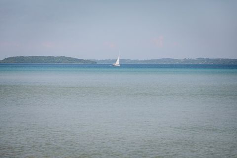 View of sailboat circling power island from the deck