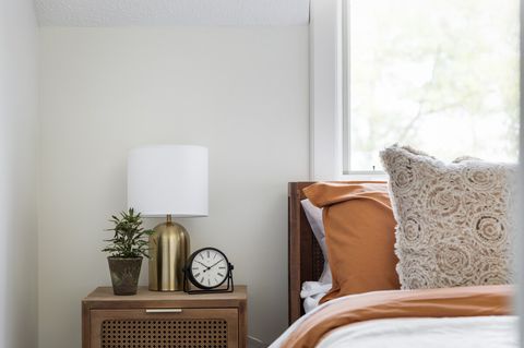 Bedroom has bedside lamps and alarm clock