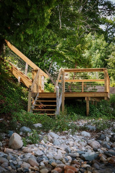 You can access the water from the deck. It is a bit rocky but gets sandy further out