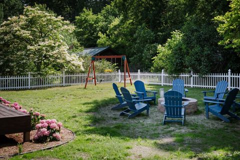 Firepit with Adirondack chairs and a kids swing set