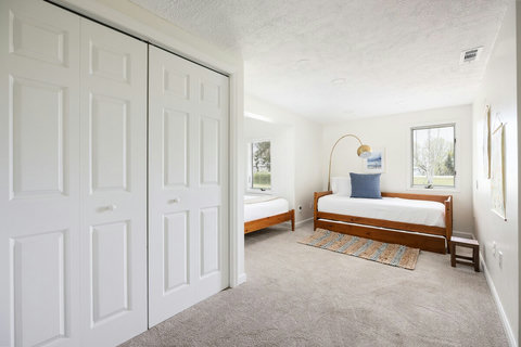 Bright twin bedroom with natural light and spacious closet