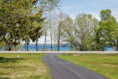 Paved driveway with peaceful lawn and beautiful water views nearby