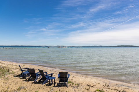 Relax in Adirondack chairs on a peaceful private beachfront