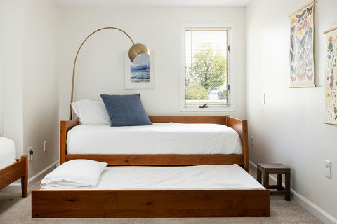 Bright twin room with pull-out trundle and cozy modern styling