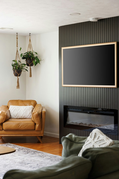 Cozy modern lounge with fireplace, TV, and stylish designer touches