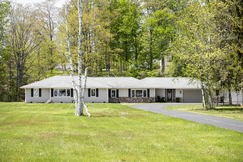 Peaceful ranch home with a huge yard, mature trees, and private drive