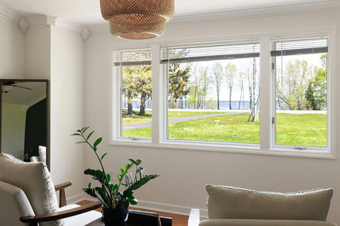 Bright lounge with large windows and serene water views