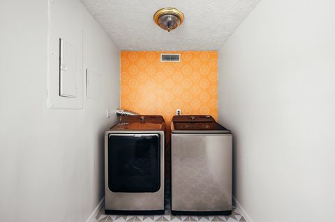 Laundry room with large capacity washer and dryer available for guest use