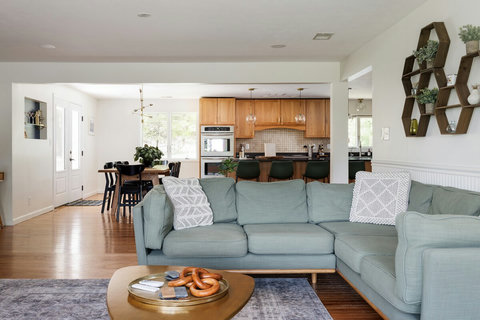 Bright open-concept living area with cozy sectional and kitchen bar seating
