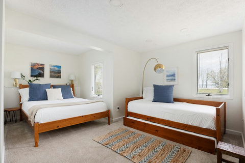 Bright family-friendly bedroom with queen bed, daybed, and natural light