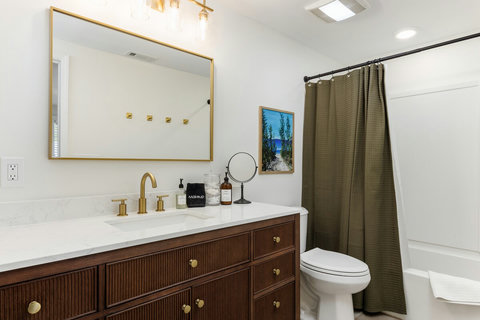Bright modern bathroom with elegant vanity and tub-shower combo