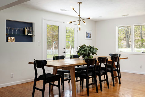 Bright dining room with seating for 8, forest views, and modern style