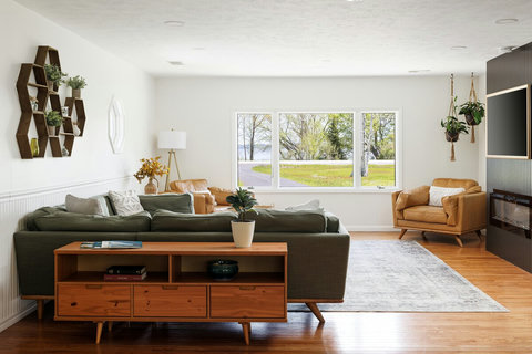Bright modern living room with large picture window and cozy fireplace