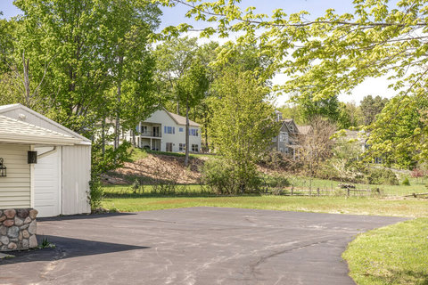 Spacious driveway with peaceful wooded views in a quiet neighborhood