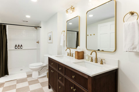 Bright double-vanity bathroom with elegant gold accents and modern style