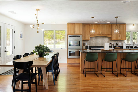 Bright open kitchen and dining space with island seating for group gatherings