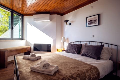 En suite bedroom with bathroom, AC and wall heater