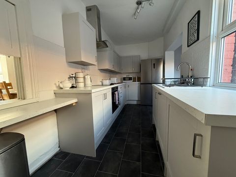 Modern fitted kitchen with American Fridge/Freezer, Dishwasher, Washing Machine, Electric Oven, Electric Hob and Microwave.