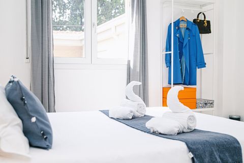 In the master bedroom, you'll also find a window overlooking our courtyard and the stunning nearby ancient stone pines. The room includes air-conditioned, a rack/wardrobe for your luggage and other items, as well as a bin.