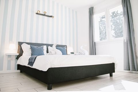 The king-size bed is extremely comfortable, and minimal bedside tables are provided for your nighttime reading. The windows feature manual blinds and drapes for your convenience.