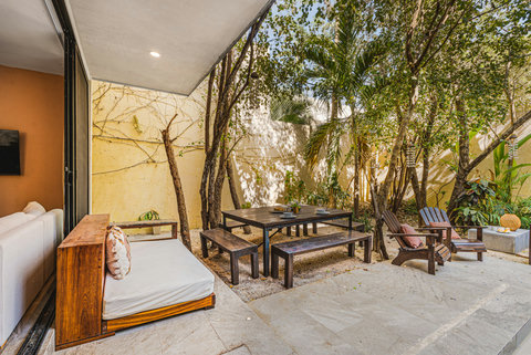 Garden with Comfortable Sofa and Outdoor Dining Table