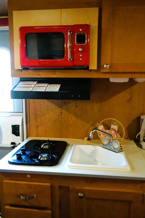 Kitchenette in each of four trailers has a stove, oven, microwave, sink, refrigerator, freezer.