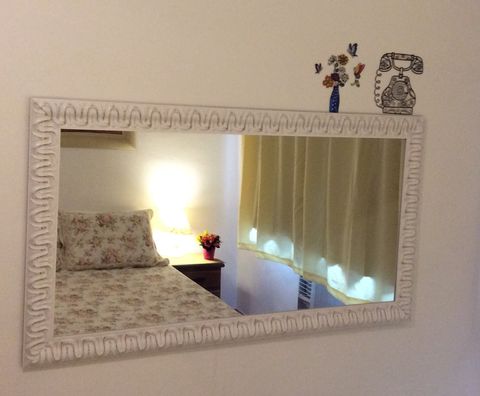 Beautiful mirror in front of the bed. 