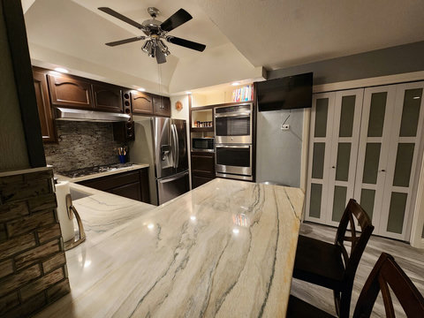 Kitchen - Extra large sink, garbage disposal, 5 burner gas stove, smart TV, ceiling fan, two ice makers in refrigerator, double ovens, microwave, coffee maker (grinds beans), toaster.
