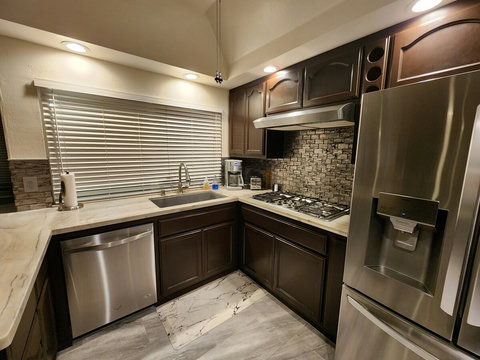 Kitchen - Extra large sink, garbage disposal, 5 burner gas stove, smart TV, ceiling fan, two ice makers in refrigerator, double ovens, microwave, coffee maker (grinds beans), toaster.