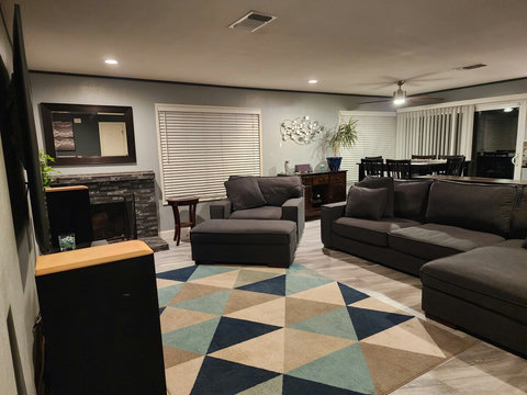 Living room - Over sized, comfortable couches. 75" Smart TV, and fireplace.