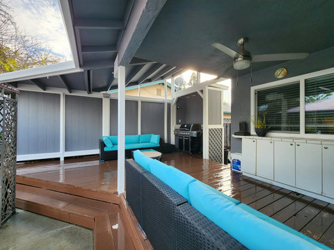 Backyard deck - ceiling fan with light, barbecue grill, outdoor couches.