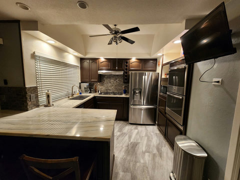 Kitchen - Extra large sink, garbage disposal, 5 burner gas stove, smart TV, ceiling fan, two ice makers in refrigerator, double ovens, microwave, coffee maker (grinds beans), toaster.