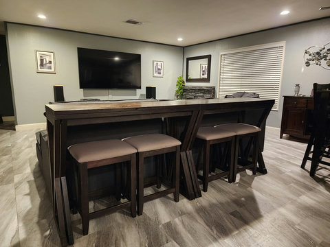 Living room/dining area - Two tables behind the couch with stools. Great for eating and watching TV or working on a laptop. Both tables fold out, doubling in size. They do have to be moved around to open them up.