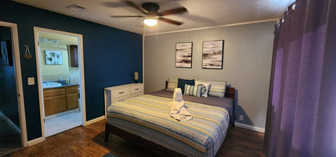 Main bedroom, king size bed double closets, ceiling fan, smart tv, attached bathroom, sliding door out to hot tub.