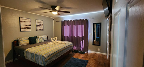 Main bedroom, king size bed double closets, ceiling fan, smart tv, attached bathroom, sliding door out to hot tub.