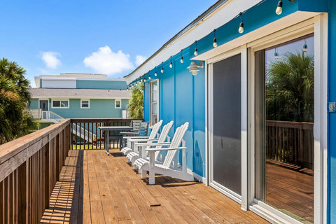 Upstairs deck with 3 adirondack chairs and a 4 person dining table.