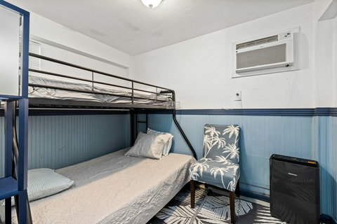 Downstairs twin over full bunk bed. Conditioned by a window A/C.