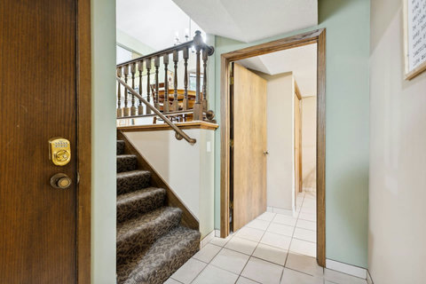 Lower level leads to 2 bedrooms, 1 bath and laundry room.
