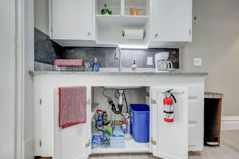 Recycle bin, fire extinguisher, cleaning supplies and extra trash bags