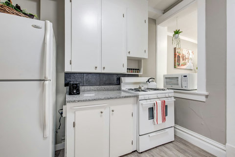 A toaster and lots of kitchen storage