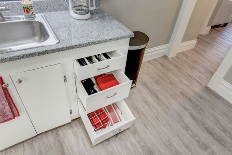 Silverware, knives, wine bottle opener, can opener, cooking utensils, hot pads, extra towels