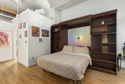 Queen-sized Murphy bed in the secondary bedroom downstairs