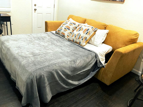 Queen size sofa bed with memory foam mattress, pillows, sheets and blanket