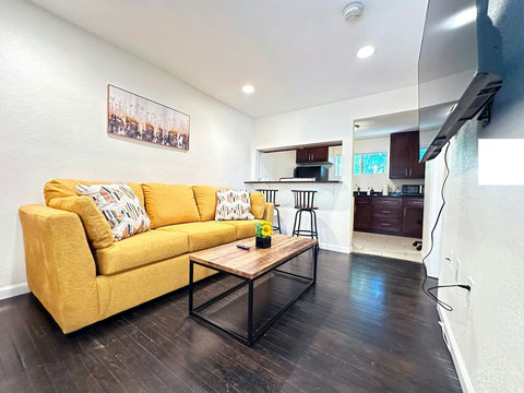 Living room with couch, coffee table, smart TV