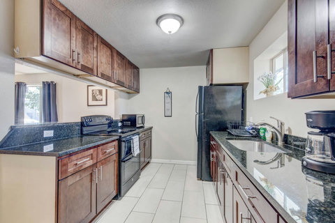 Large kitchen with a stove, oven, microwave, coffee maker, refrigerator and freezer